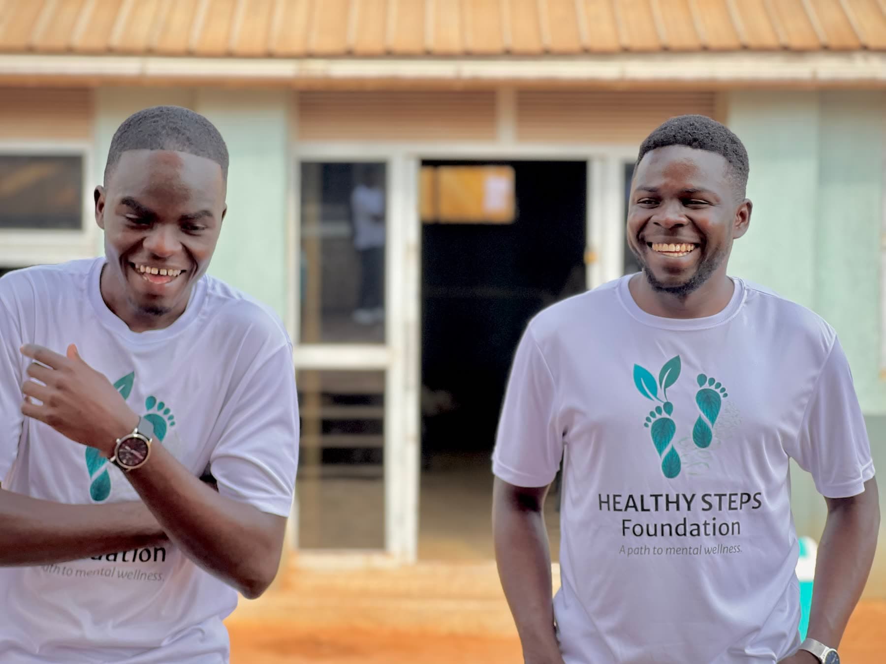 Two Healthy Steps Foundation team members laughing in branded shirts