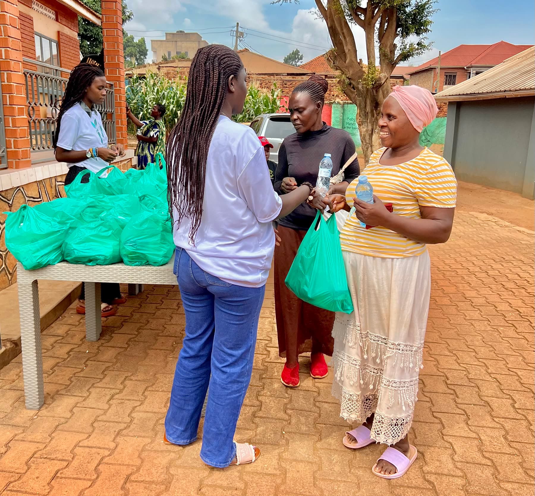Healthy Steps Foundation volunteers distributing staple food bags in Kampala, Uganda